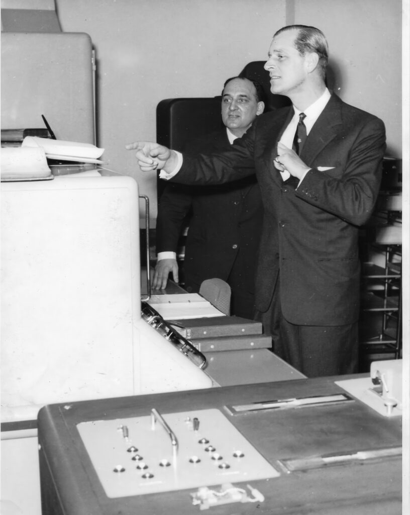 David Caminer with Prince Philiplooking at LEO documentation at LEO's computer works and factory on Minerva Road in Acton, London 22 March 1960