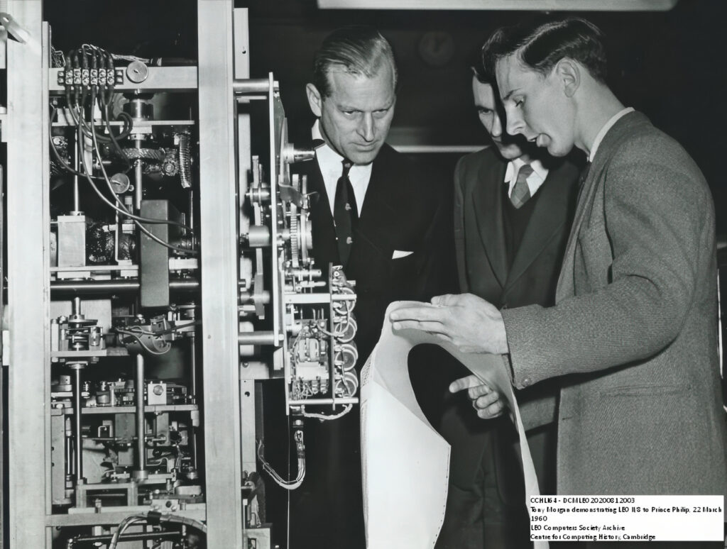 Tony Morgan with Prince Philip showing a printoout from the Samstronic printer on LEO II/8 at LEO's computer works and factory on Minerva Road in Acton, London 22 March 1960